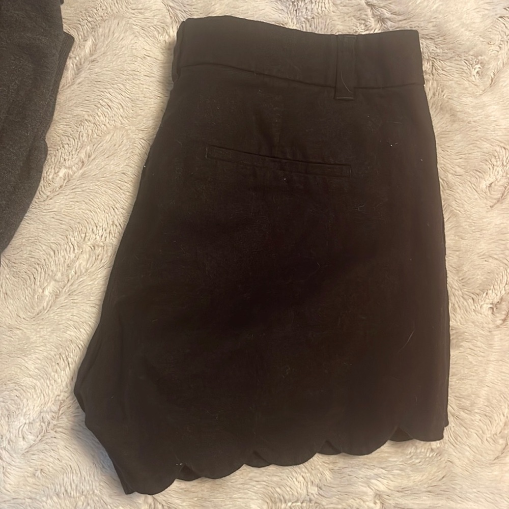 Black scalloped edge shorts.